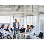 A team sits in a sleek office and has a meeting.