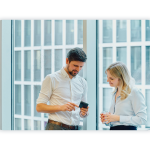 Two colleagues talking and looking at a smartphone.