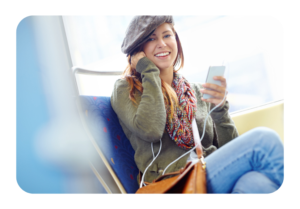 Woman on a train ride smiling at the camera.